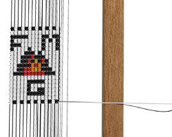A completed pattern of beads on a beading loom.